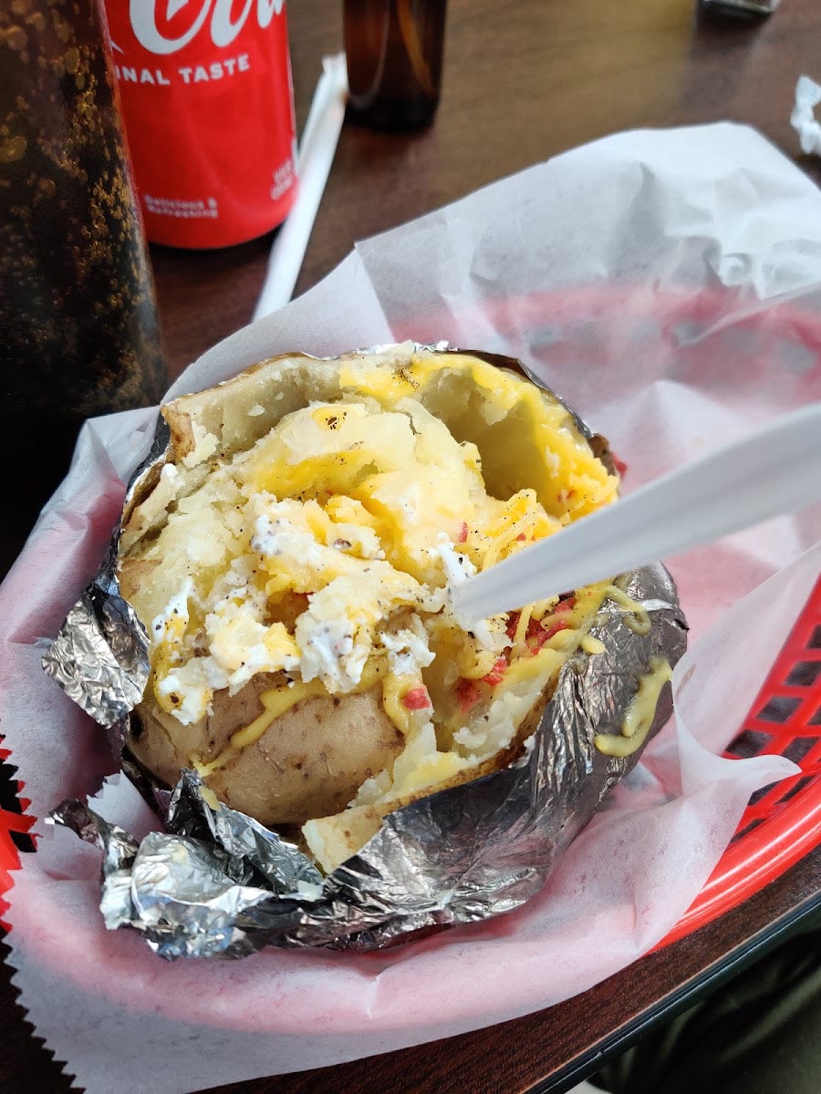 Baked potato loaded with meat, cheese and sour cream