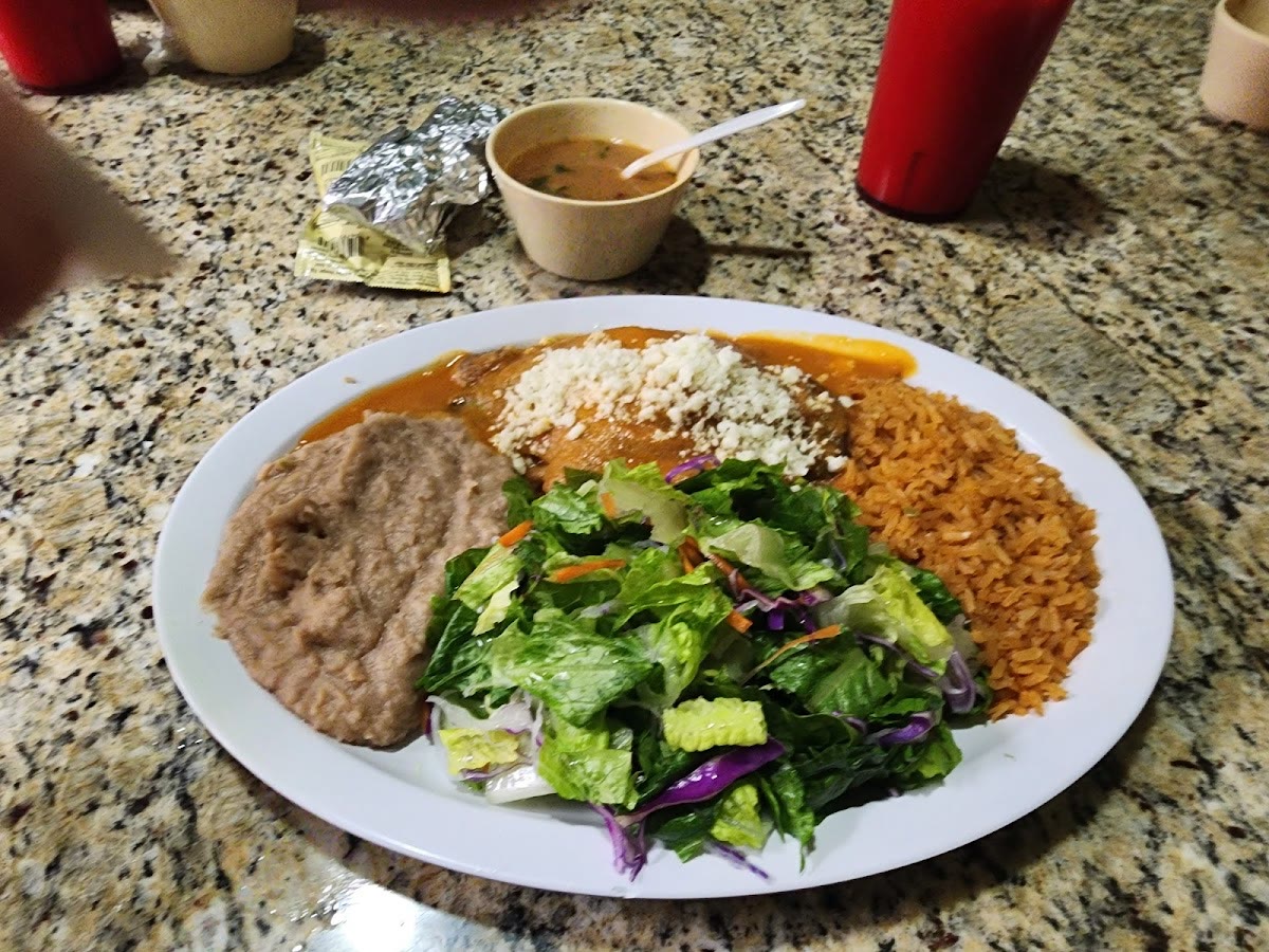 Enchilada plate with rice, beans and salad